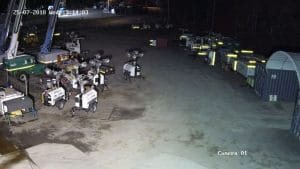 CCTV camera footage of parked heavy equipment and machineries at night.